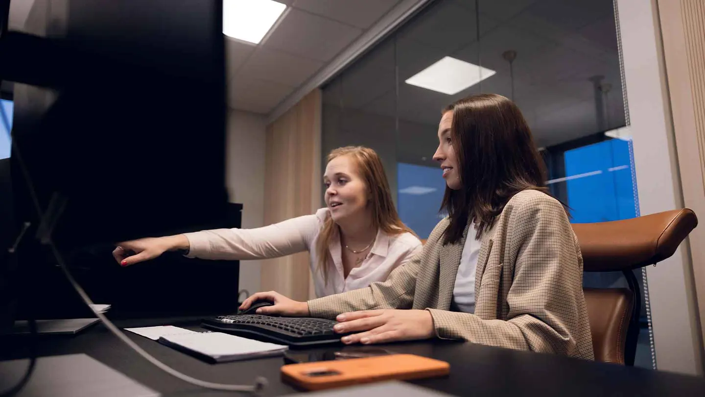 two women looking at a computer